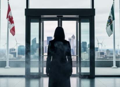 “A blurred figure at a modern Canadian government entrance with climate haze and distant wind turbines in the background, representing stalled climate leadership.”